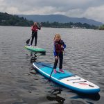 5 year old paddleboarder learning to paddling on Derwent water with her Mum