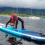 youngster doing the crab on Paddleboard